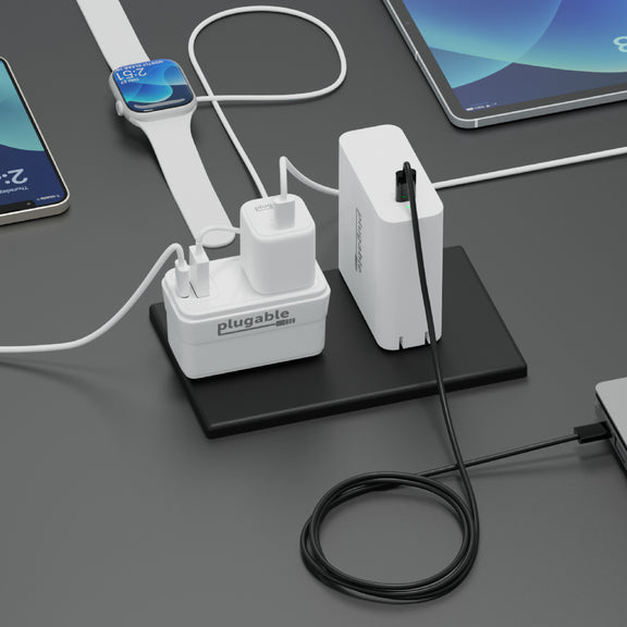 An example image of the PS1-CA1 outlet passthrough charger connected next to an outlet and sharing space with another charger.