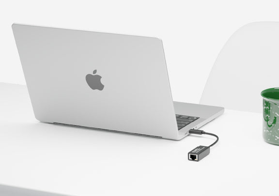 Image of the USBC-E1000 connected to a macbook on a desk