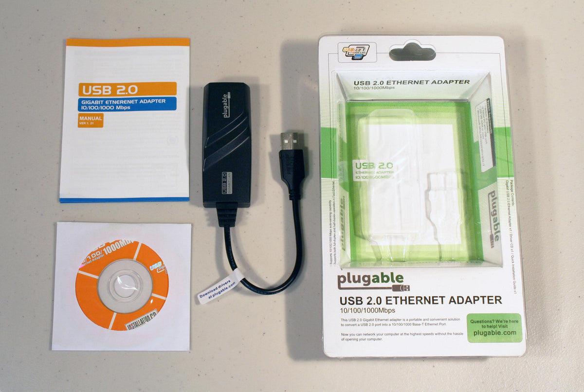 Plugable USB2-E1000 10/100/1000Mbps Ethernet adapter, manual, installation CD, and retail packaging.