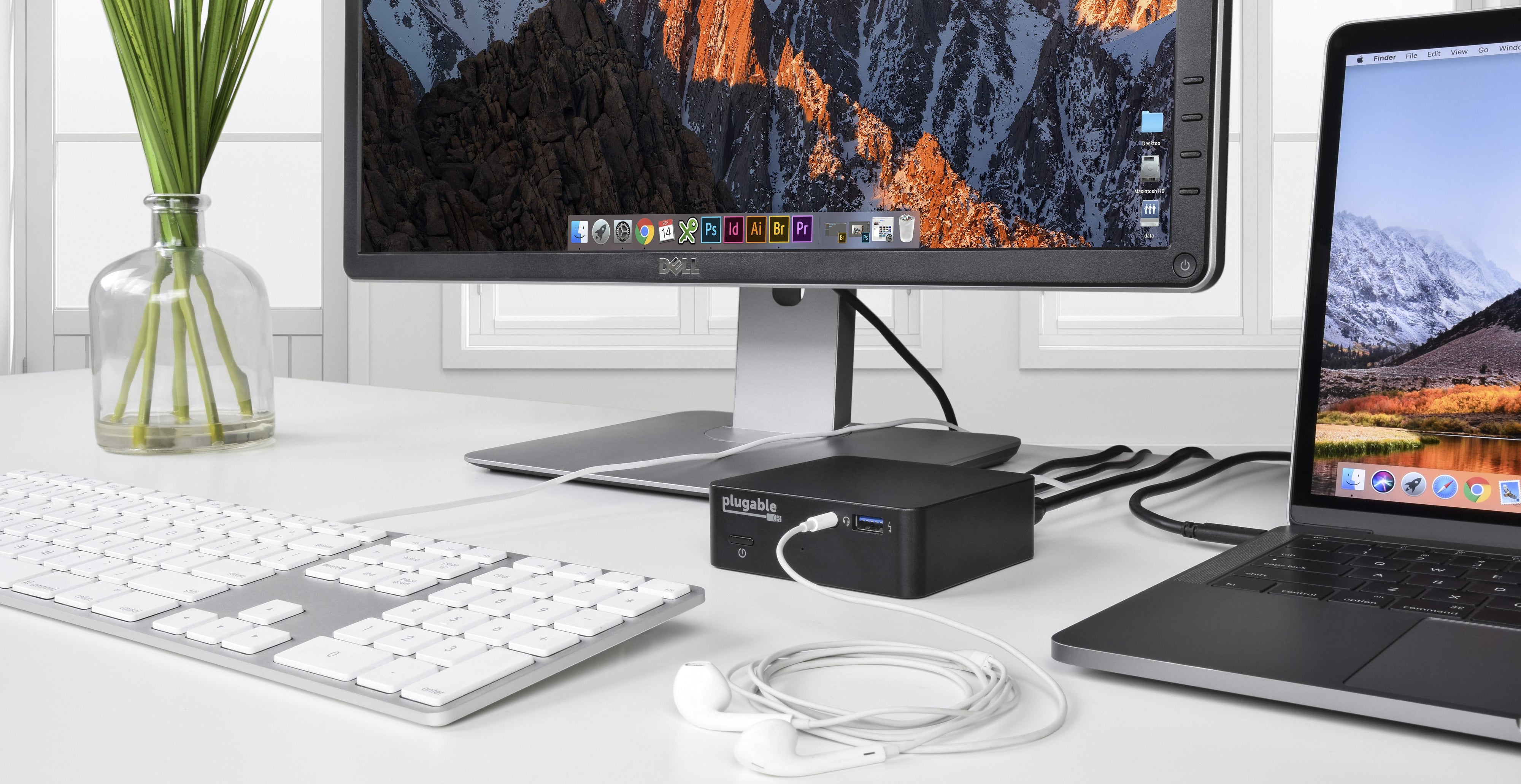 Plugable UD-CAM dock on a desk connected to keyboard, mouse, laptop, and headphones