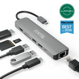 Plugable USBC-7IN1E 7-in-1 USB-C hub with HDMI, SD, microSD, USB ports, and Ethernet, alongside various connected cables and