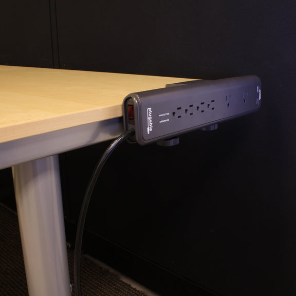 An image of the ps6-usb2dc clamped to a desk.